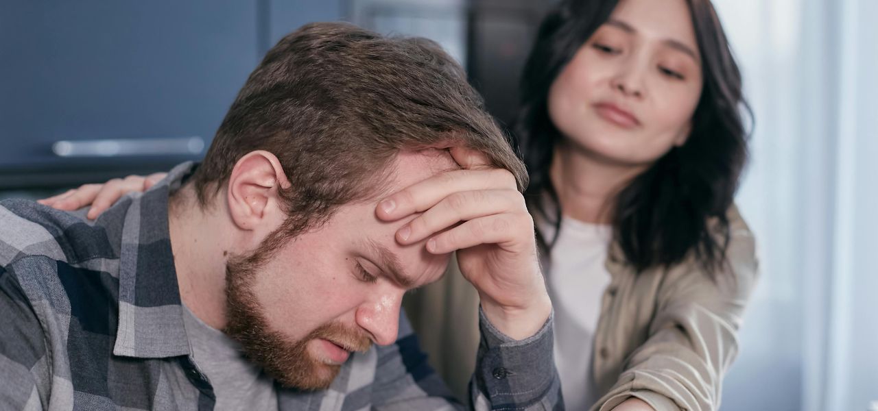 Grieving man with partner